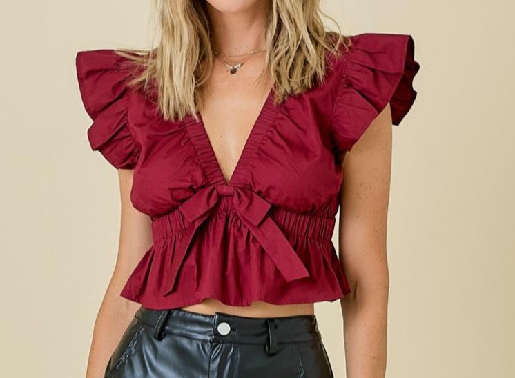 Deep v neck babydoll top with bow and ruffle detail
