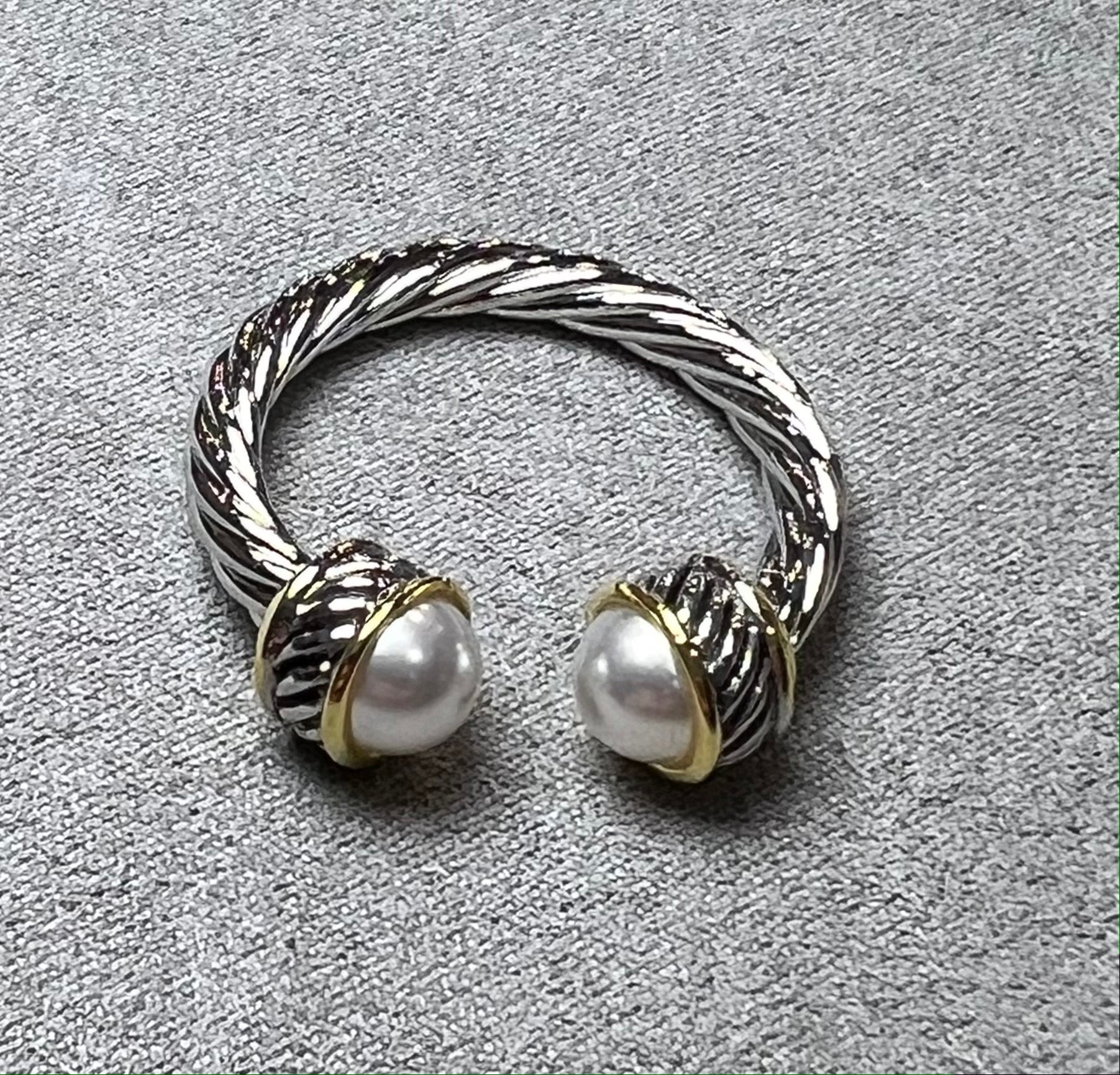 Twisted metal open ring with pearl ends